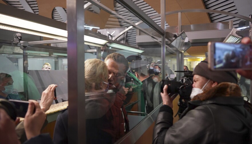 Alexei Navalny kisses his wife Yulia as he is detained by police at the passport control after arriving at Sheremetyevo airport outside Moscow on Jan. 17, 2021.