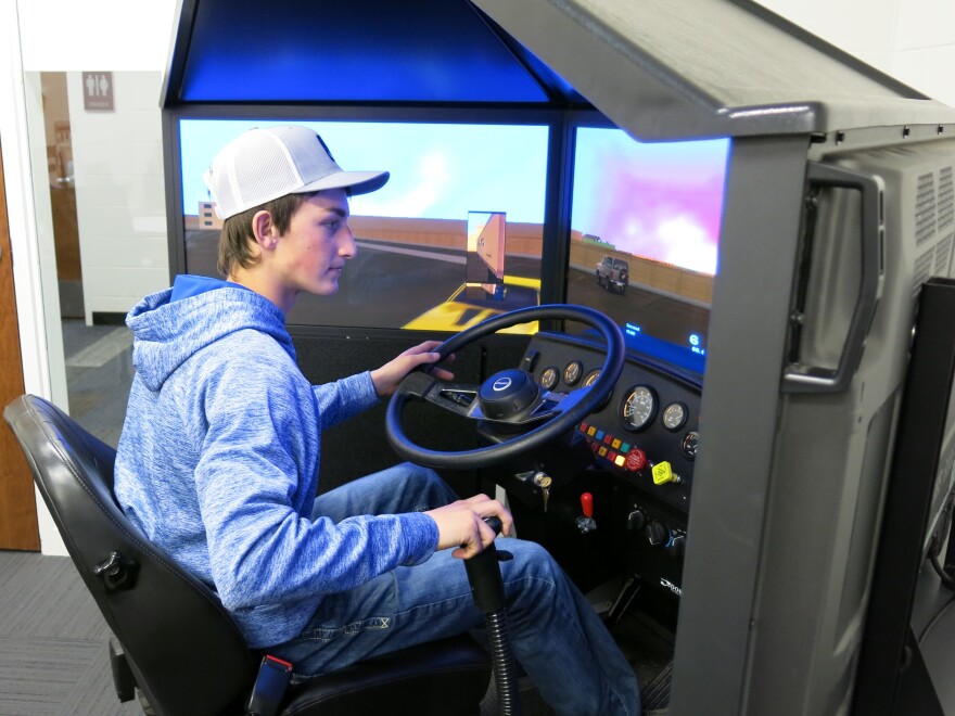 Watford City High School senior Jake Lepell practices driving on the school district's $20,000 truck driving simulator. The region's oil boom has created a demand for truck drivers.