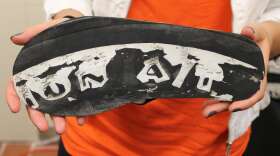 Deux Mains brand merchandising manager Thais Cuachio holds a sandal made from leather  &amp; an old car tire. Photo: Matthew Peddie, WMFE