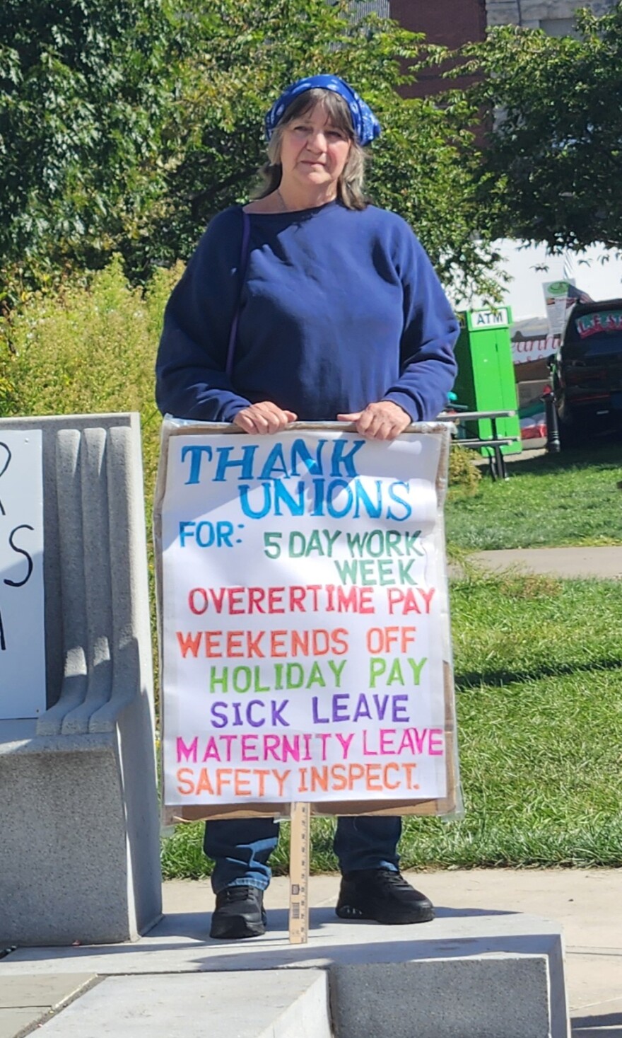A woman at the Labor Day event in Scranton holds a sign listing rights secured by unions.