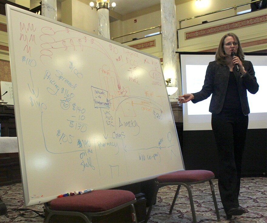 Montana Auditor's Office Chief Legal Counsel Kris Hansen draws a diagram while explaining the concept of pharmacy benefit mangers during a lobbying effort for SB71 on January 17, 2019.