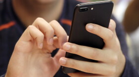 FILE - In this Sept. 16, 2017, file photo, a person uses a smart phone in Chicago.