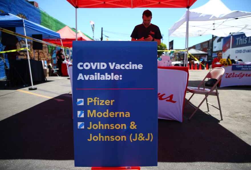 A sign displays the types of COVID-19 vaccination doses available at a Walgreens mobile bus clinic on June 25, 2021 in Los Angeles, California.