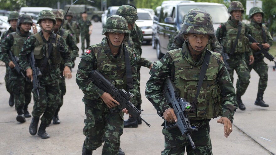 Thai soldiers patrol after army chief Gen. Prayuth Chan-ocha announced that the armed forces were seizing power after months of political turmoil.