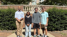Civic Literacy Teacher Cristofer Wiley (left) stands with Reynolds High School students Tandy Adjei, Grant Cameron and Patrick Rais-Bahrami 