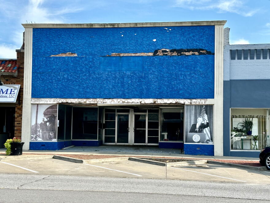 An empty store front in Osawatomie, Kansas, shows photos of Teddy Roosevelt and Barack Obama