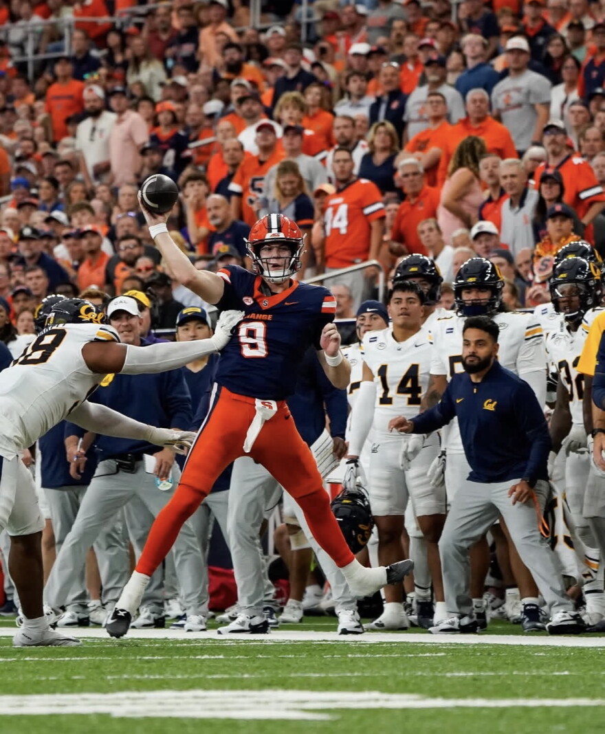 Syracuse quarterback Steve Angeli (9, Blue) evades a sack during a 21-18 loss to California Saturday.