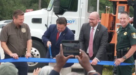 Florida Governor Ron DeSantis cuts the ribbon to denote completion of the State Road 777 (Rover Road) widening project in Sarasota County, Friday.