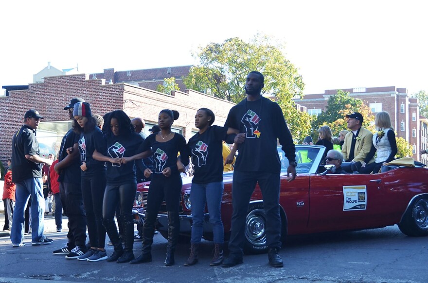 Student protesters block a red car arm-in-arm during the 2015 Mizzou Homecoming Parade at Ninth Street and University Avenue. 