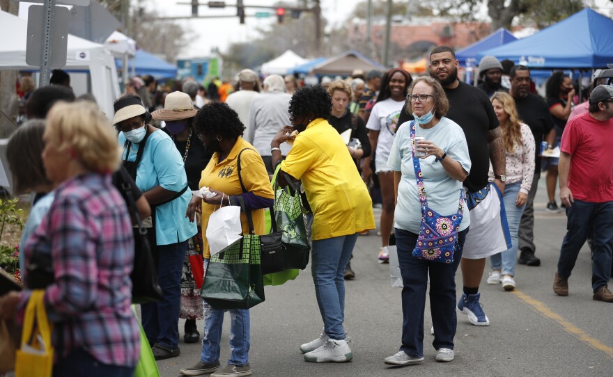 Festival are seen walking during the 2022 Publix Tampa Bay Collard Festival in St. Petersburg, Florida, on Saturday, February 19, 2022. Photo by Octavio Jones for WUSF