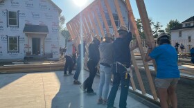 Volunteers from Notre Dame raise a wall Tuesday in a Habitat for Humanity build in the 700 block of Harrison Avenue in South Bend.