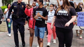 CMPD Capt. Brad Koch talks with marchers in a protest Sunday, May 31, in uptown Charlotte. 