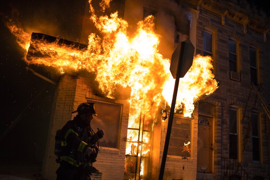 Maryland Gov. Larry Hogan declared a state of emergency on Monday evening and ordered the National Guard into the city as fires burned and residents stood on their stoops trying to understand the anger.