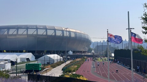 A practice track runs to the right of a stadium