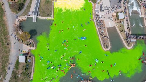 The U.S. National Whitewater Center dyes its manmade river rapids bright green during it's "Green River Revival" in 2023. The event is held each year around Saint Patrick's Day.