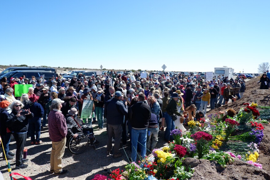 A crowd gathers on the roadside near Zorro Ranch to demand greater accountability for the crimes of Jeffrey Epstein