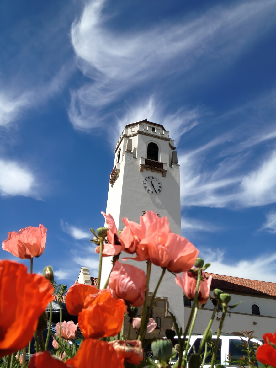 The Boise Depot tower is in the background with red flowers in front.