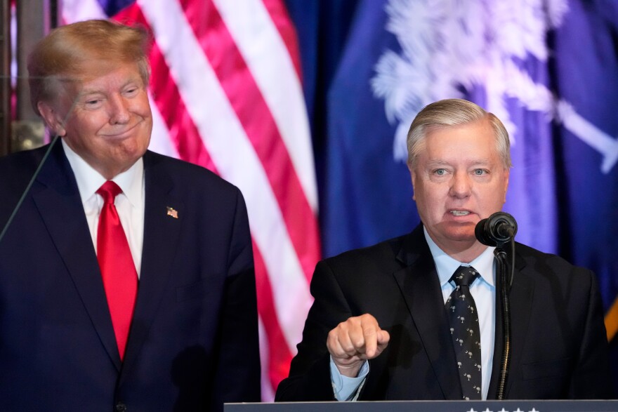 FILE - Former President Donald Trump listens as Sen. Lindsey Graham, R-S.C., speaks at a campaign event at the South Carolina Statehouse, Jan. 28, 2023, in Columbia, S.C. (AP Photo/Alex Brandon, File)