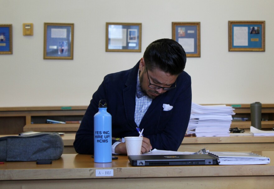 Bilingual reading teacher Miguel Rodriguez takes notes during teacher in-service at Democracy Prep at the Stewart Campus Aug. 1, 2018.