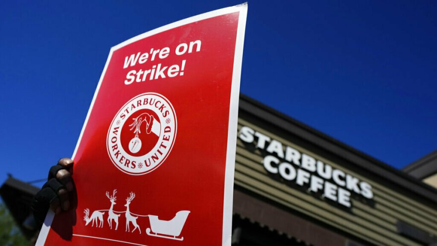Starbucks employees strike Nov. 17 outside their store in Mesa, Ariz. Starbucks workers around the U.S. are planning a three-day strike starting Friday as part of their effort to unionize the coffee chain's stores.