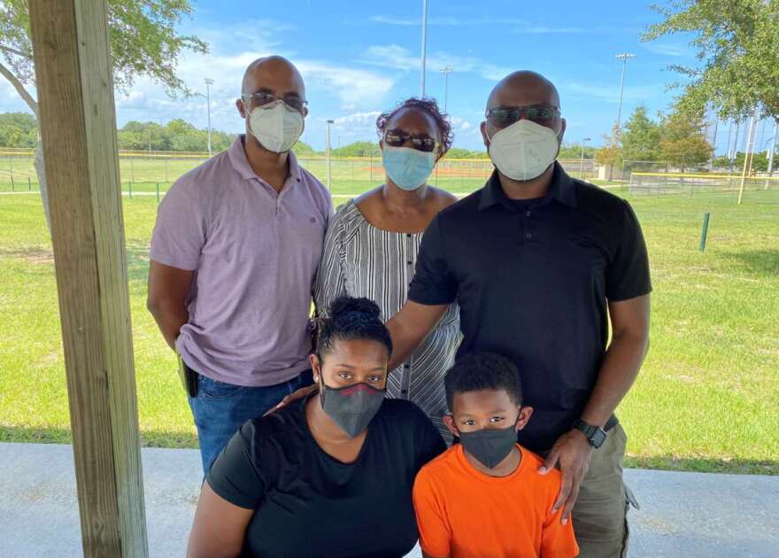 Members of the Hosey family spoke with a reporter at Viera Regional Park on Sunday. In the back row are, from the left, Dr. Damani Hosey; his mother, Aisha Hosey; and brother, Jabari Hosey. In the front are Jabari's wife, Nicole Hosey, and son Jalani. Photo: Joe Byrnes, WMFE