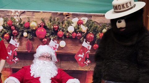 Santa Claus and Smokey Bear visit DEC Region 5 headquarters for the annual children's holiday party 