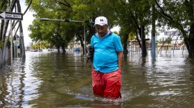 A man crosses the flooded intersection in the Little Havana neighborhood of Miami on Saturday.
