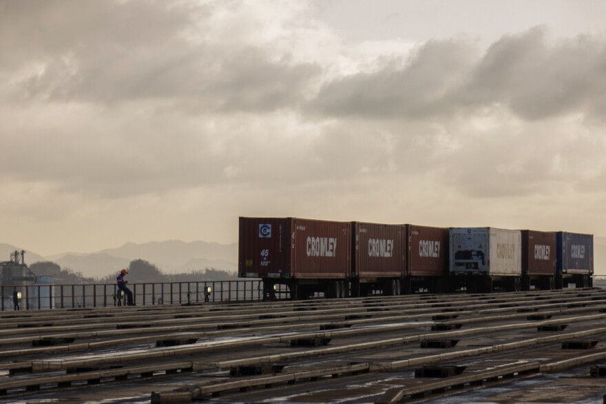 Crowley shipping containers are unloaded from a barge in the port of San Juan. The company started unloading shipments on Saturday. By Friday, it will have received four ships, with a total of about 4,000 loaded crates.