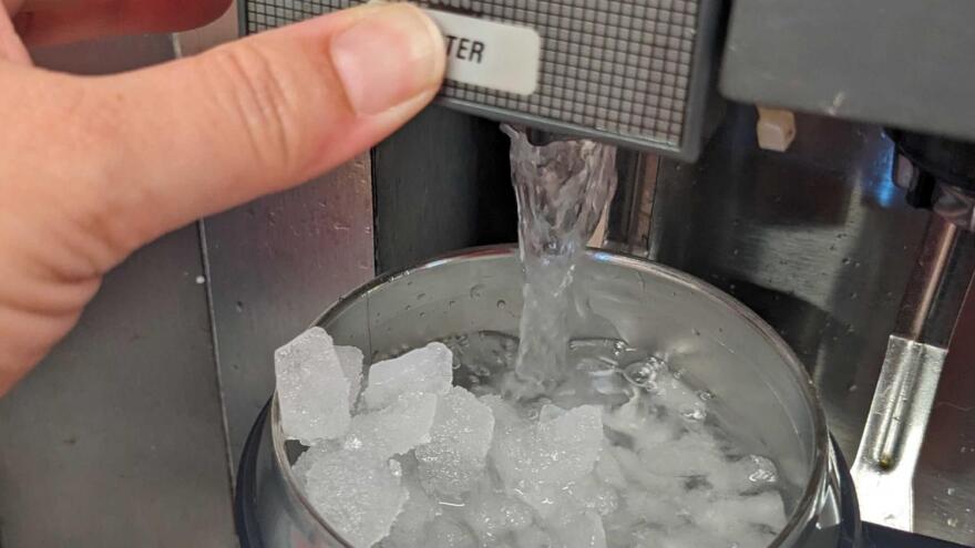 A cup of water filled with ice. 