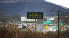 A sign on Interstate 81 in Scranton, Pennsylvania, on Monday, November 30, 2020, informs drivers of the state's travel order that people visiting or returning to the state have a negative COVID-19 test quarantine for 14 days. (AP Photo/Ted Shaffrey)