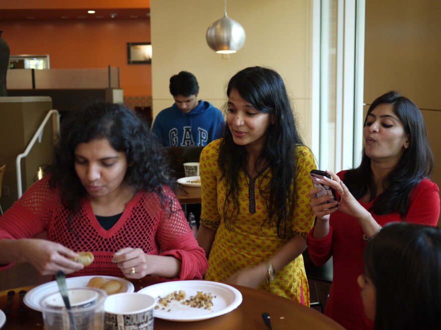 Upasana Kone (center) cheers on some Microsoft employees at an Indian street food competition to raise money for Child Rights and You, a nonprofit that conducts child development projects in India and the U.S.