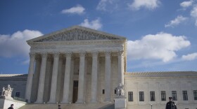 U.S. Supreme Court police stand on the plaza in front of the courthouse in January. The court heard arguments Monday about whether an American had a right to know why their foreign-national spouse had been refused entry into the country.