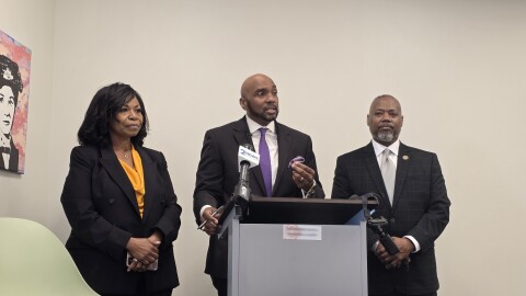 Damario Solomon-Simmons (center) addresses the media in Tulsa on Tuesday, March 10, 2026, flanked by Freedmen descendants Rhonda Grayson (left) and Jeff Kennedy (right).