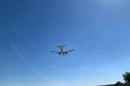 plane flies in blue sky