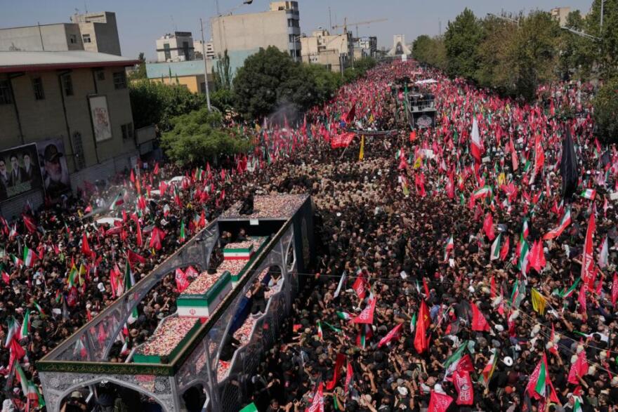 The truck carrying the coffins of the slain Iranian Supreme Leader Ayatollah Ali Khamenei and members of his family makes its way through mourners during the funeral procession toward Azadi Tower in Tehran, Iran, Monday, July 6, 2026. (Vahid Salemi/AP)