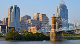 A 2014 view of the Cincinnati skyline.  The Roebling Bridge is in the foreground and the Great American tower with it's "crown" are shown just behind it.