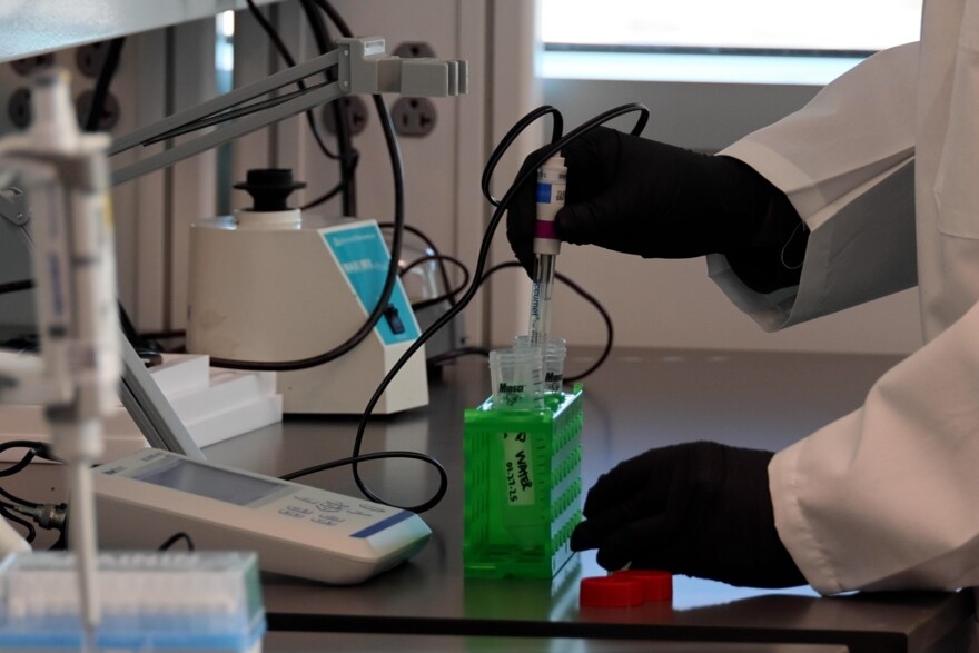 Above: a researcher at IU Indianapolis gives a demonstration during the opening of IU LAB. While research spending has grown on campus, its new research designation resulted from a change in Carnegie Classification standards.