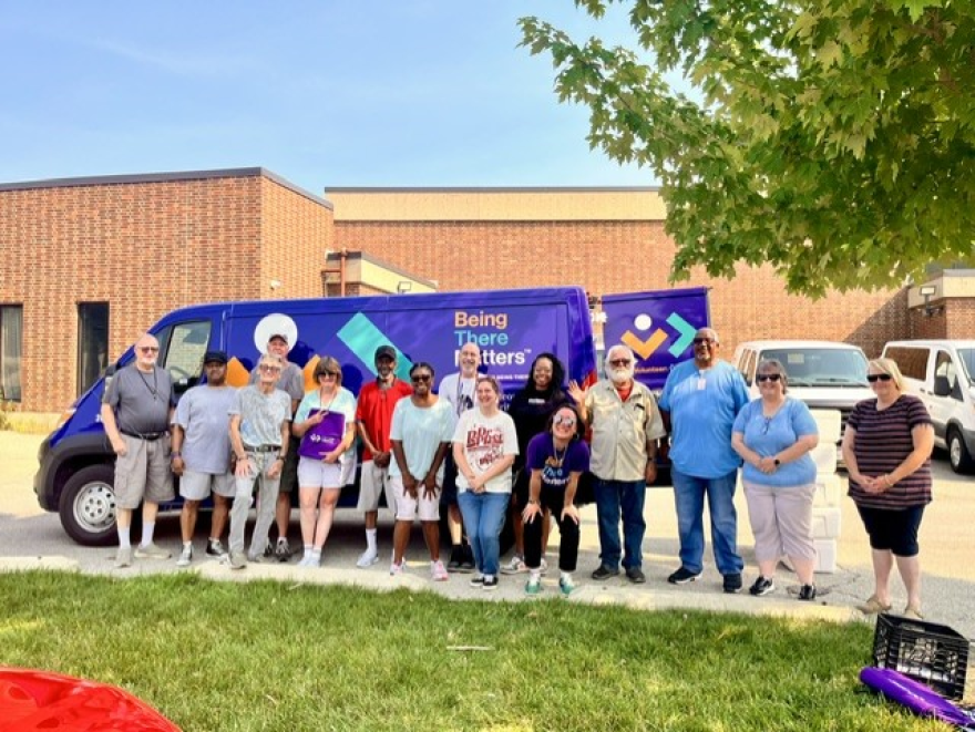 Members of LifeCare Alliance stand in front of a Meals on Wheels delivery van in Dayton