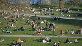 People enjoy high temperatures on April 22 in Stockholm. Sweden has not imposed the extraordinary lockdown measures seen across Europe.