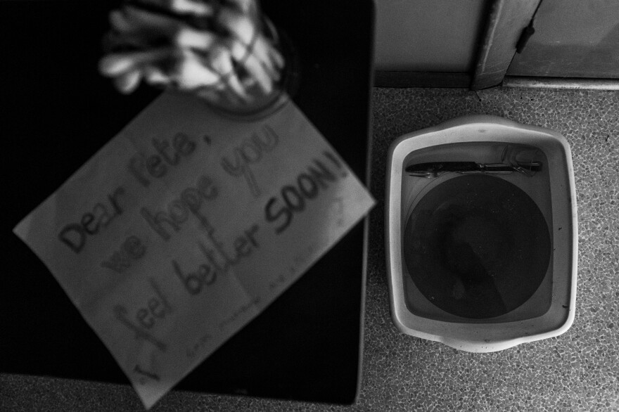 Pete: Children from the neighborhood made me a card and sent me breadsticks. At right, a bucket filled with bleach solution served to disinfect my dishes after meals.