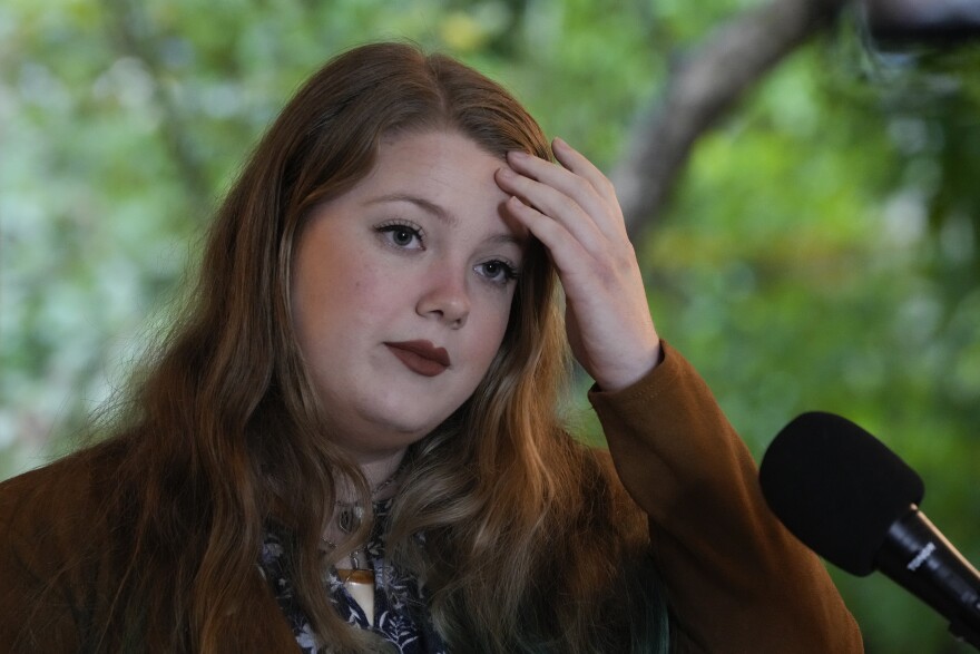 Climate activist Delaney Reynolds, 22, speaks at a press conference where U.S. Rep. Charlie Crist, D-Fla, was announcing a solar power initiative for the state, Wednesday, Feb. 9, 2022, in South Miami. Reynolds, who founded The Sink or Swim Project at the age of 15, continues to run her non-profit and push for policy change, while also pursuing dual PhD and law degrees. (AP Photo/Rebecca Blackwell)