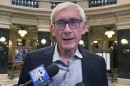 Wisconsin Gov. Tony Evers speaks with reporters in the state Capitol, Oct. 17, 2023, in Madison, Wis. Lockdowns at two of Wisconsin's oldest and most understaffed prisons are being eased, a move announced by Gov. Evers that comes less than a month after inmates filed a federal lawsuit alleging that current conditions at the Waupun prison amount to cruel and unusual punishment.