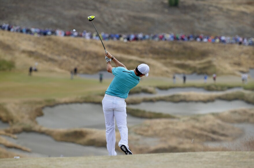 Rory McIlroy, of Northern Ireland, watches his tee shot on the fourth hole during the first round of the U.S. Open at Chambers Bay.