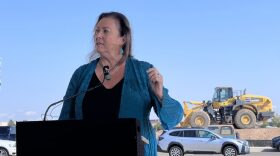 Bernalillo County Commissioner Barbara Baca speaks before a front end loader parked on a dirt lot that will soon become an affordable apartment complex on Albuquerque’s West Side, thanks to a new round of state funding.