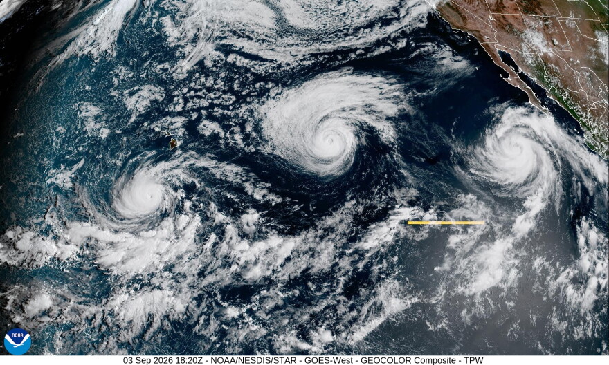 An infrared satellite image shows Hurricane Lowell, right