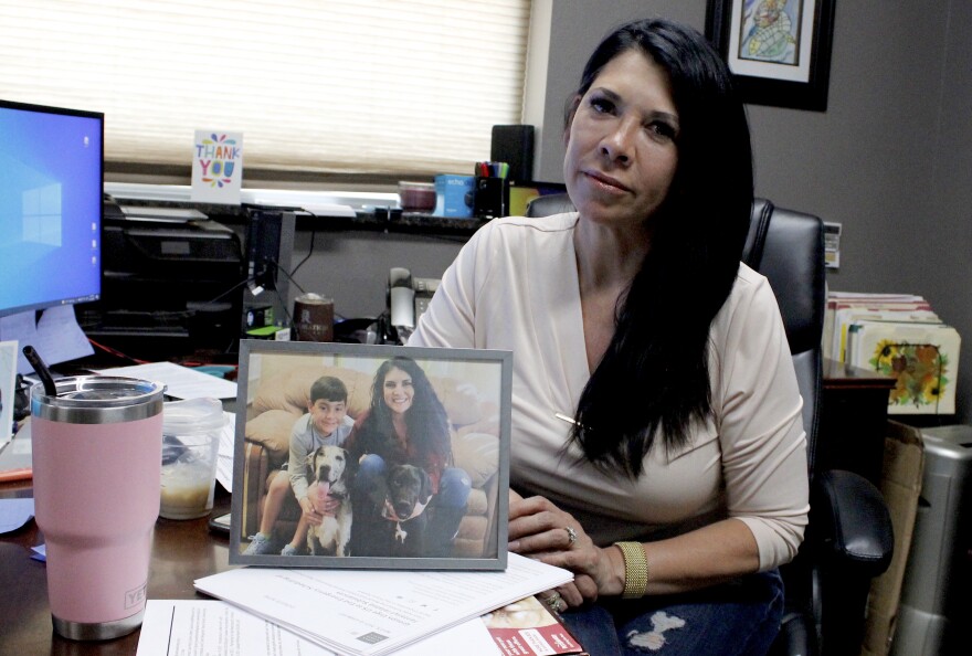 Andrea Thomas holds a picture of her daughter and grandson