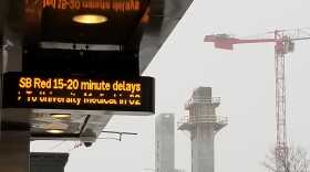 Photo of sign that reads "SB Red - 15-20 minute delays."
