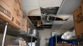 Pictured: Ceiling tiles missing and stained from water damage in a storage room for the cafeteria of the Bertha C. Boschulte Middle School.