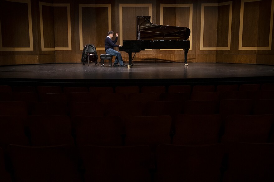 Bidini rehearses in a darkened theater to prepare for his 2020 performance at the Folly. 