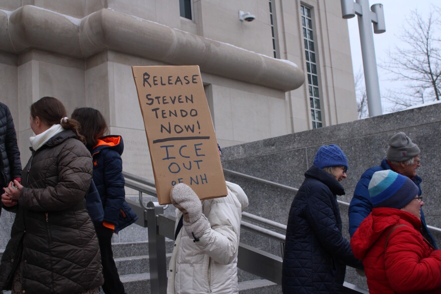 About a dozen supporters of Steven Tendo, a Vermont Pastor and asylum seeker from Uganda, stand outside the federal courthouse in Concord ahead of his hearing on Friday, Feb. 20, 2026.